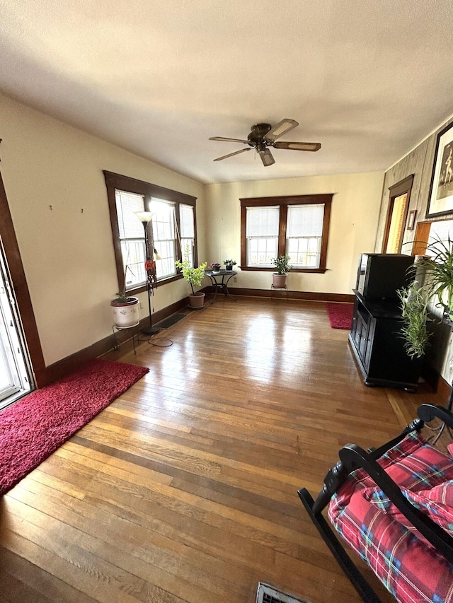 living room with a textured ceiling, hardwood / wood-style flooring, plenty of natural light, and ceiling fan