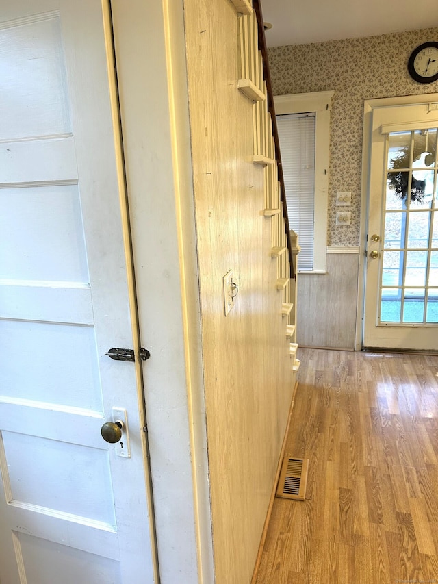 corridor featuring light hardwood / wood-style floors