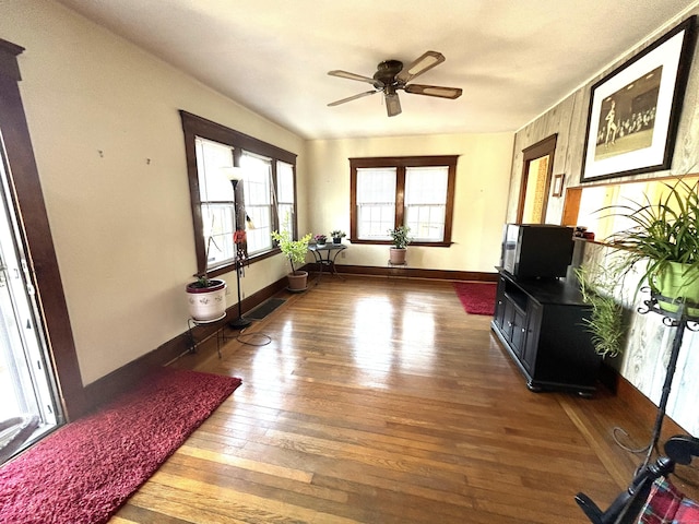 interior space with ceiling fan and wood-type flooring