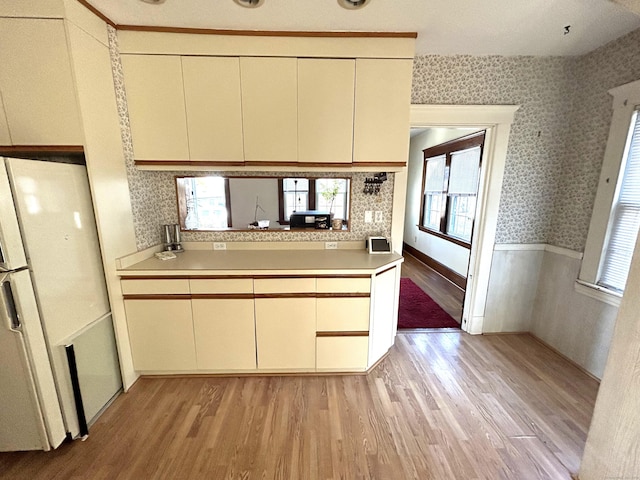 kitchen with cream cabinetry and light wood-type flooring