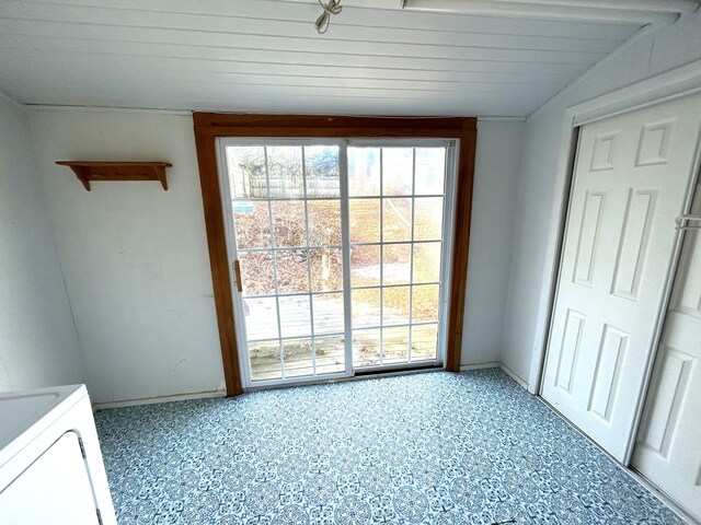 unfurnished dining area with wooden ceiling, vaulted ceiling, and washer / dryer