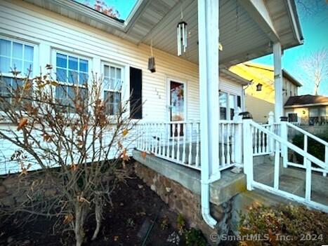 view of side of property featuring covered porch