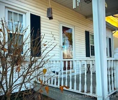 view of side of home with covered porch