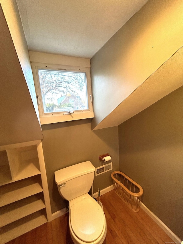 bathroom featuring hardwood / wood-style flooring and toilet