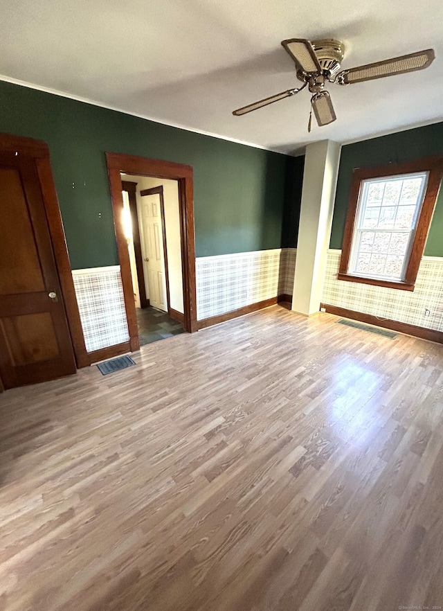 spare room featuring wood-type flooring and ceiling fan