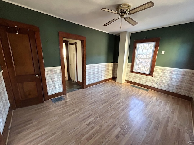 empty room featuring hardwood / wood-style floors and ceiling fan