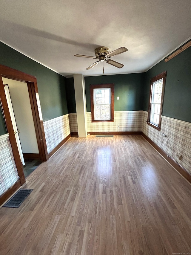 unfurnished room featuring hardwood / wood-style flooring, ceiling fan, and a textured ceiling