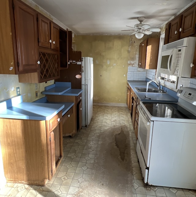 kitchen with white appliances, backsplash, ceiling fan, and sink