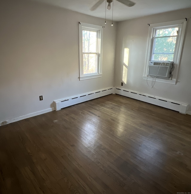 empty room with ceiling fan, cooling unit, and dark wood-type flooring