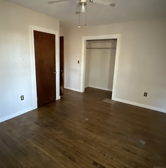 unfurnished bedroom featuring dark hardwood / wood-style flooring, a closet, and ceiling fan