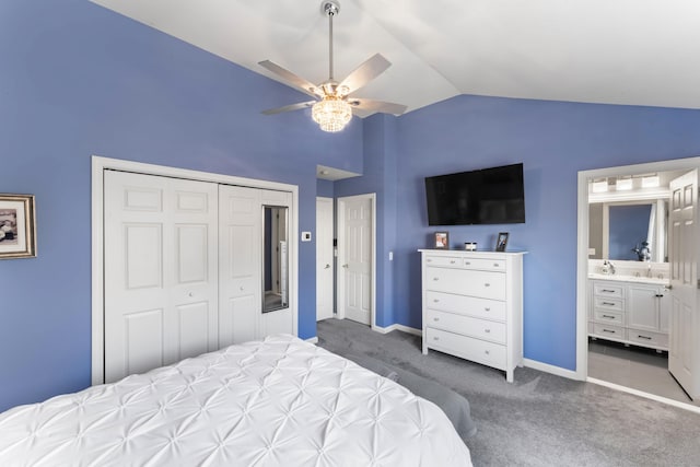 carpeted bedroom with ceiling fan, vaulted ceiling, connected bathroom, and a closet