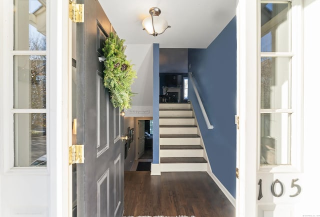 entryway featuring a healthy amount of sunlight and dark wood-type flooring