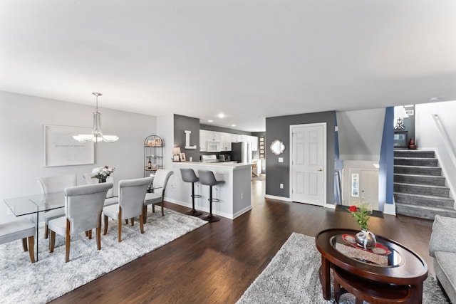 living room featuring dark hardwood / wood-style floors and a notable chandelier