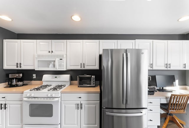 kitchen featuring white cabinetry and white appliances