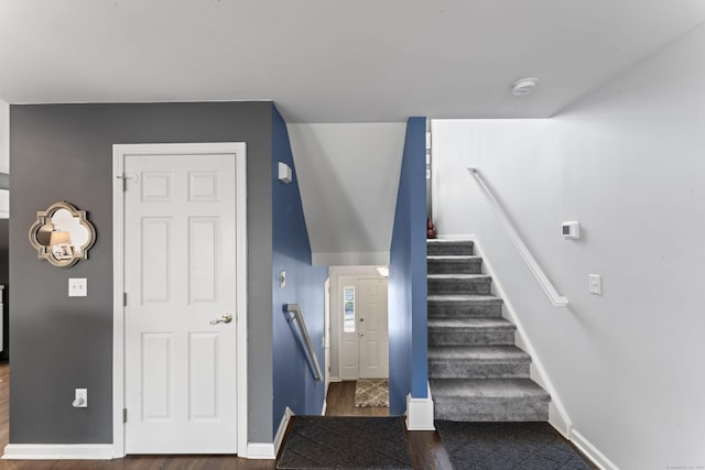 stairs featuring hardwood / wood-style floors