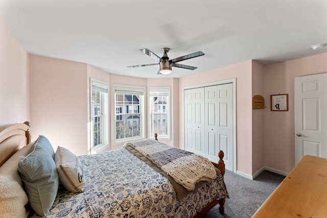 carpeted bedroom with ceiling fan and a closet