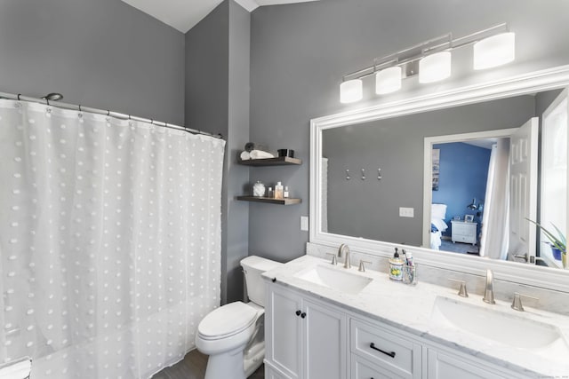 bathroom featuring vanity and toilet