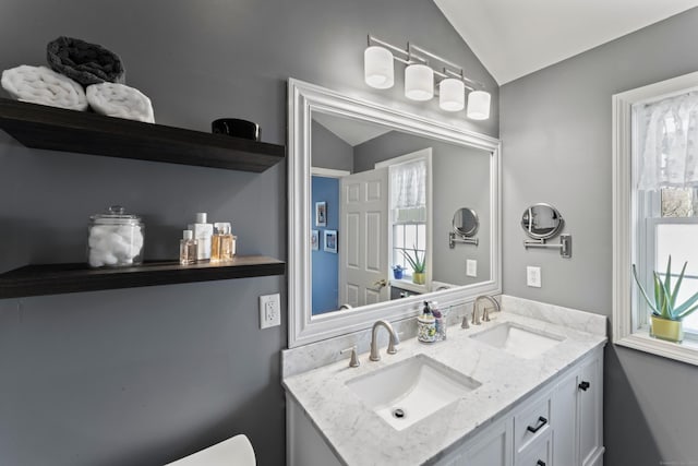 bathroom featuring vanity and vaulted ceiling