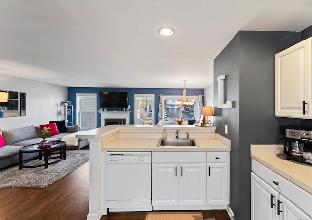 kitchen with sink, dark hardwood / wood-style flooring, white dishwasher, decorative light fixtures, and white cabinets