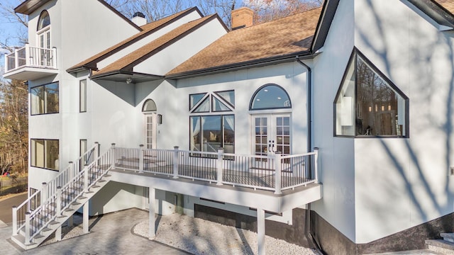 rear view of house featuring french doors