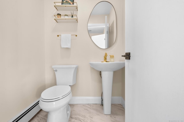 bathroom with toilet and a baseboard heating unit