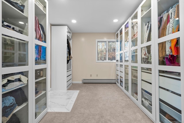 walk in closet with light colored carpet and a baseboard radiator