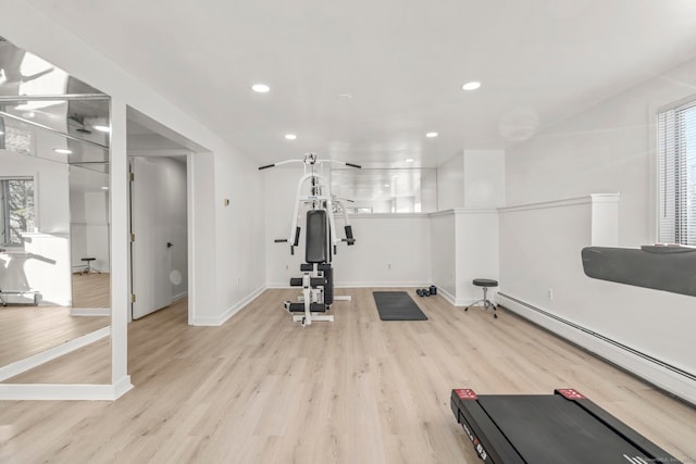 exercise area featuring light hardwood / wood-style flooring and a baseboard heating unit