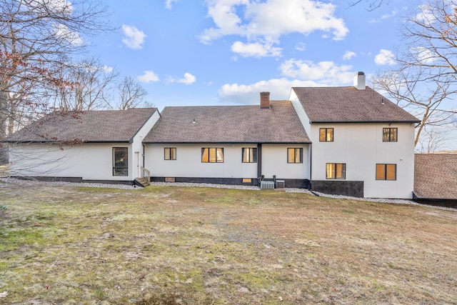 rear view of property with a yard