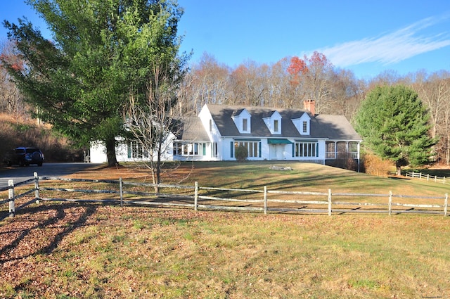 view of front of house featuring a rural view and a front lawn