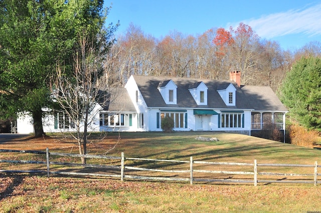 new england style home with a front yard