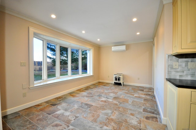 interior space with recessed lighting, an AC wall unit, ornamental molding, stone tile flooring, and baseboards