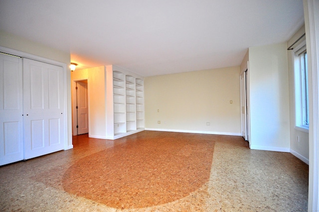 interior space featuring baseboards and built in features