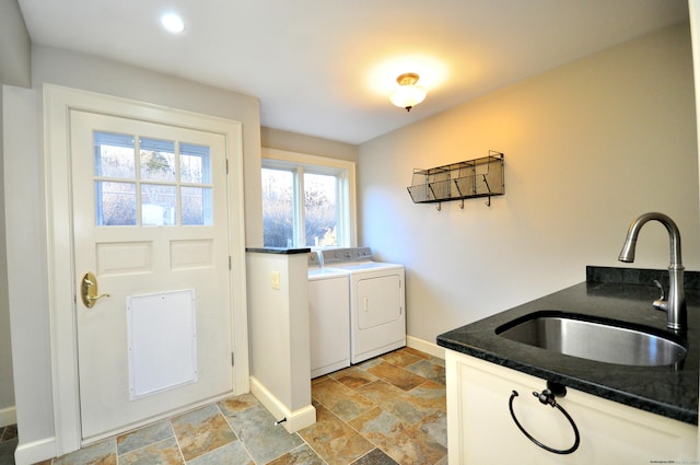 laundry area with washer and clothes dryer, cabinets, and sink