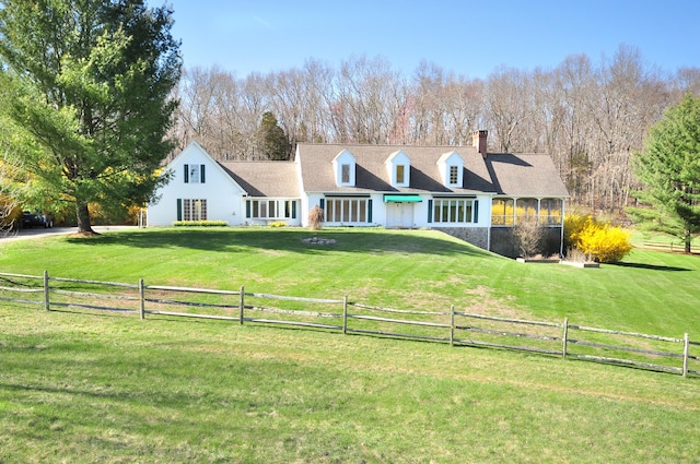 back of property featuring a lawn, a chimney, and fence private yard