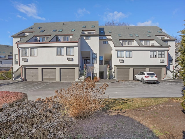 back of property with a garage