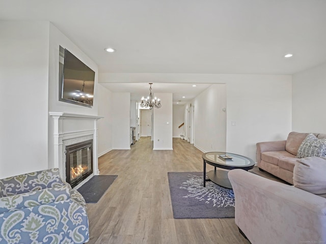 living room with a chandelier and light hardwood / wood-style floors