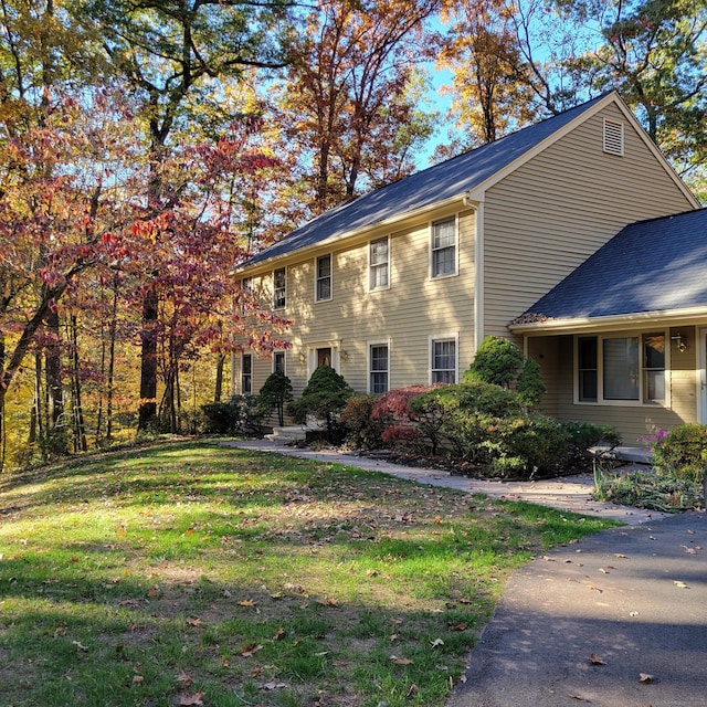 view of side of home with a yard