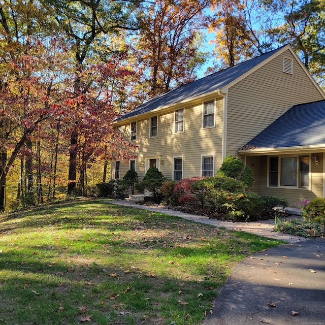 view of property exterior with a yard