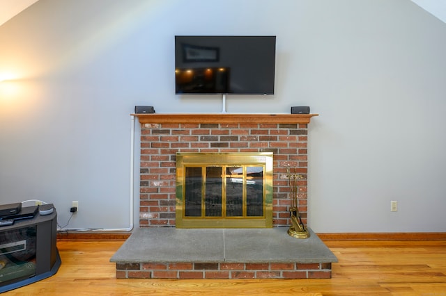 room details featuring hardwood / wood-style flooring and a brick fireplace