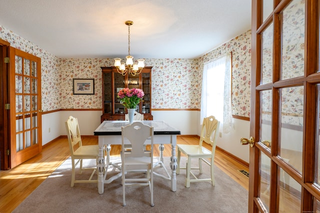 dining room with a chandelier and light hardwood / wood-style flooring