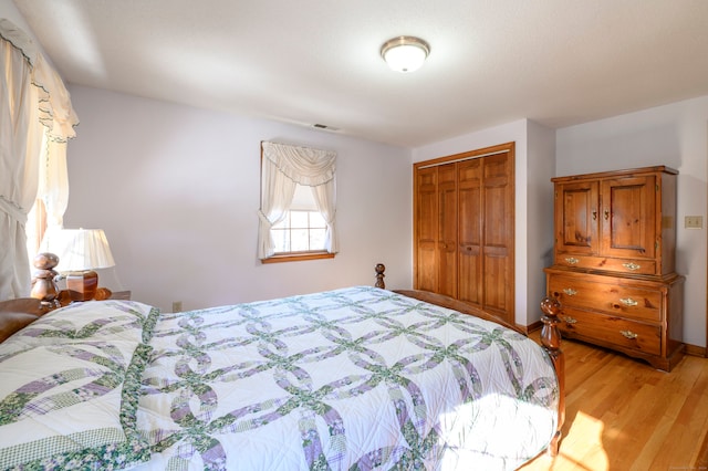 bedroom featuring light hardwood / wood-style floors and a closet