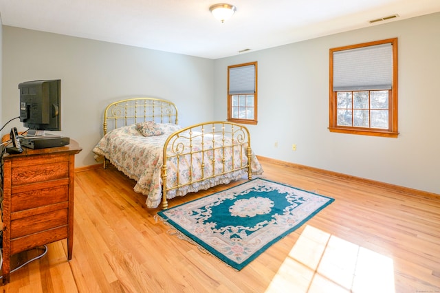 bedroom featuring light hardwood / wood-style floors and multiple windows