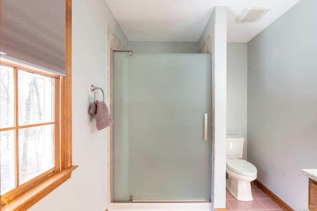 bathroom with tile patterned flooring, vanity, toilet, and an enclosed shower