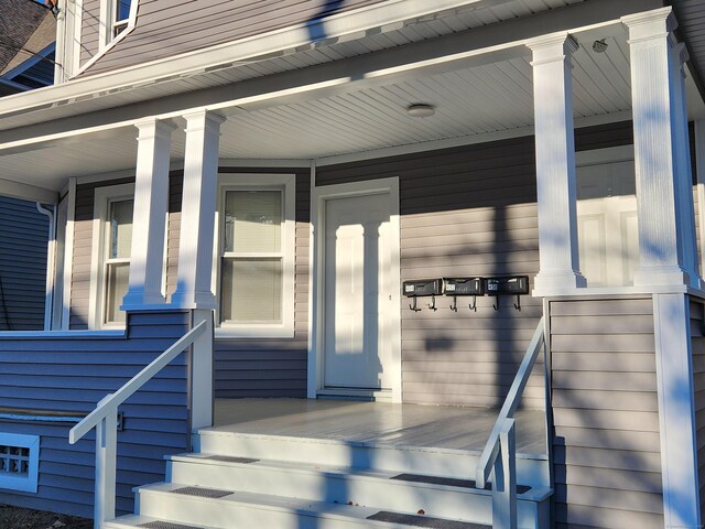 view of exterior entry with covered porch