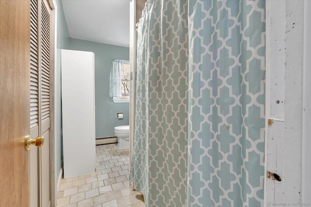 bathroom with toilet, tile patterned floors, and a baseboard heating unit