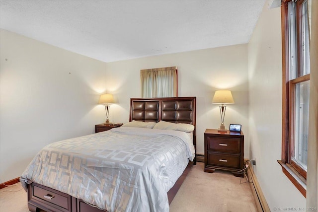 carpeted bedroom featuring baseboard heating and a textured ceiling