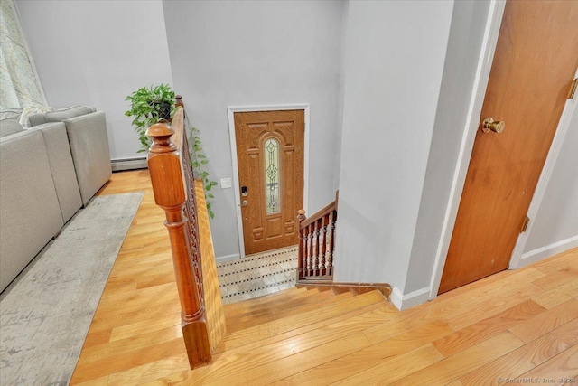 entrance foyer with wood-type flooring and a baseboard radiator