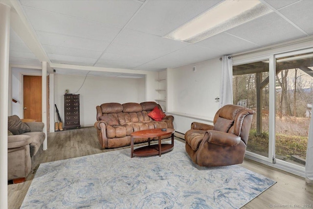 living room featuring a baseboard radiator and light hardwood / wood-style flooring