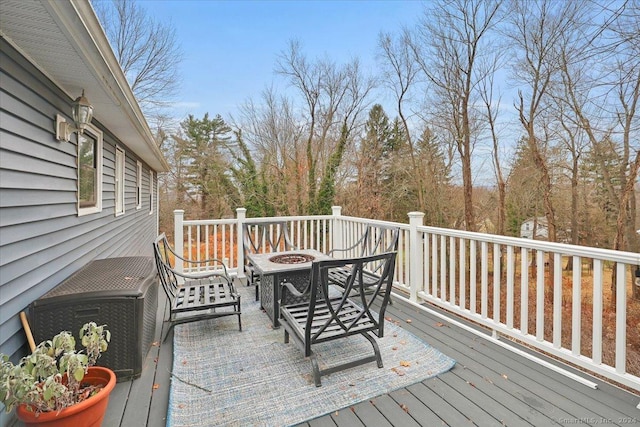 wooden terrace with a fire pit