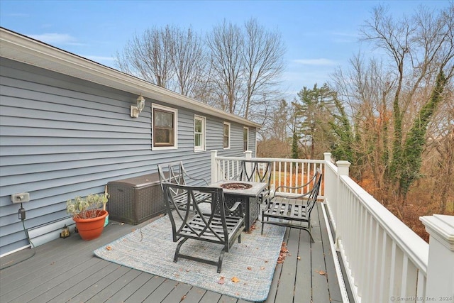 wooden terrace featuring a fire pit